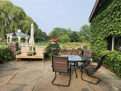 Outdoor patio seating at Honeymoon Trail Winery with gazebo and vineyard views